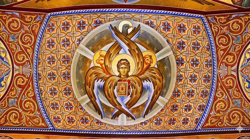 Dark, gothic-style tetramorph illustration featuring the four symbolic faces from Ezekiel & John's vision—a lion, ox, eagle, and human—emerging from a swirling, organic form with thorny, lightning-like accents. The artwork has a distressed, mystical tone, aligning with East Of Eden’s grunge Indian Christian streetwear themes of biblical imagery and divine intensity.