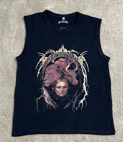 Navy blue sleeveless tank top featuring the Tetramorph graphic from Revelation, with the faces of a lion, ox, eagle, and man surrounded by lightning-like details and gothic lettering, laid flat on a gray surface. A bold piece from the grunge Indian Christian streetwear collection.