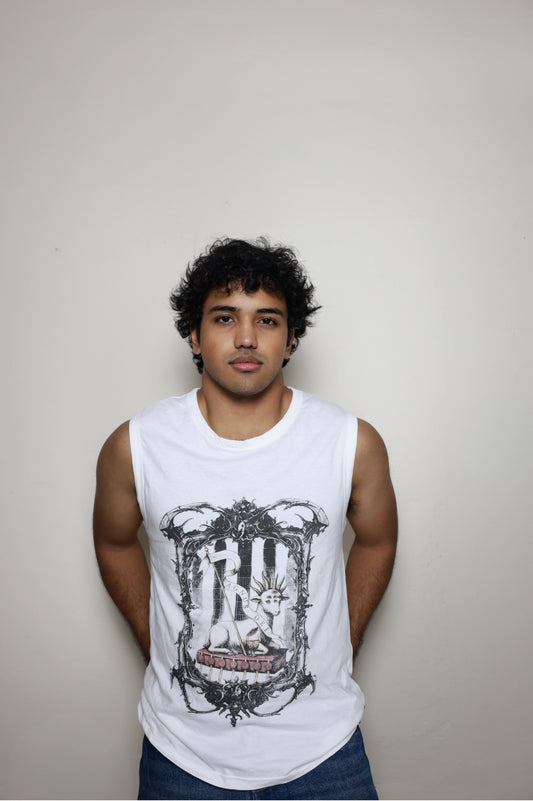 White sleeveless tank top with a bold Agnus Dei design from Revelation: the lamb is shown with seven eyes and horns, resting on the book with seven seals and holding a banner, set within an ornate gothic frame — a key piece in your grunge Indian Christian streetwear line.