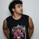 Model wearing a black sleeveless tank top featuring the Tetramorph graphic from Revelation, depicting a lion, ox, eagle, and man encircled by lightning-like branches and gothic lettering. A statement piece from the grunge Indian Christian streetwear collection.