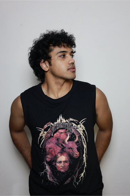 Model wearing a black sleeveless tank top featuring the Tetramorph graphic from Revelation, depicting a lion, ox, eagle, and man encircled by lightning-like branches and gothic lettering. A statement piece from the grunge Indian Christian streetwear collection.